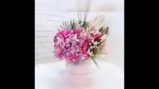 Glass arrangement with artificial mixed with cap mixed and dried flowers