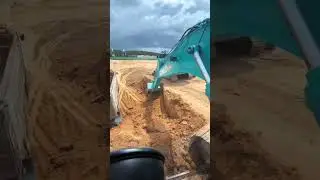 First-person perspective of excavator loading soil