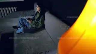 Woman is spending evening at home in front of TV playing video game with joystick