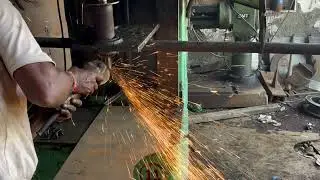 Man Using Grinder Machine to Smooth Boring Machine Surface | Industrial Machinery in Action