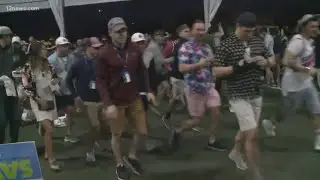 Hundreds of fans run to the 16th hole at the WMPO