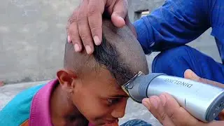 headshave boy barber by clipper haircut in village Pakistan