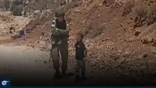 Palestinian child confronts an Israeli soldier