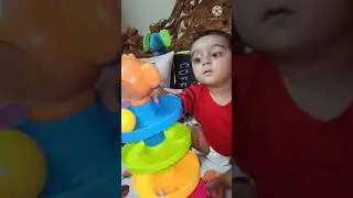 Baby playing with ball drop rolling and swirling tower ramp- educational toy