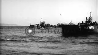 Landing Ship Tanks, Landing Craft Tanks and Sherman tanks approach a beach in Sou...HD Stock Footage