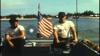 Papa boat with a 30 caliber Machine gun mounted on it patrol the beach in DaNang,...HD Stock Footage