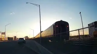 Driving west on historic Route 66 next to AmTrak Railroad Train during the evening sunset