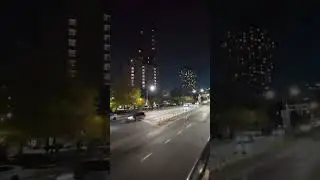 Open top bus drive through New York at night