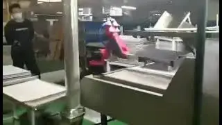 Auto Robot arm pick and place leather in Cutting Machine in Auto-trimmings factory.
