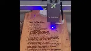 xtool burning a recipe on cutting board.