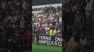 son giving shirt to a fan