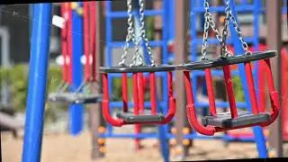 Slow motion of swings at empty children playground in residential area