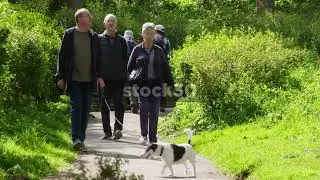 People Walking Dog Down Path, South Cliff Gardens, Scarborough, UK