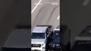 Police climb through a car window to rescue driver during medical emergency