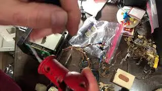 Pin from Tron Cocktail Red Joystick is removed using a jewelers flat head to access trigger button