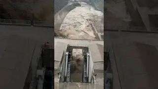 Heavy rain fall filled dam with silt & trash resulting flood released by dam gate opening