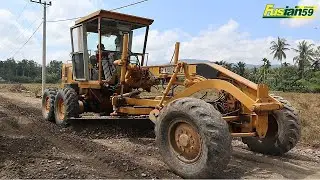 Caterpillar 120G Motor Grader Spreads Road Material