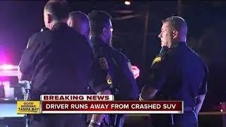 Police search for driver who ran away from crash leaving female passenger pinned in SUV