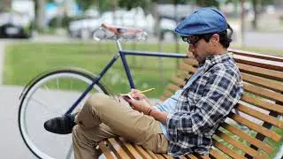 Free Footage - man writing to notebook or diary on city street