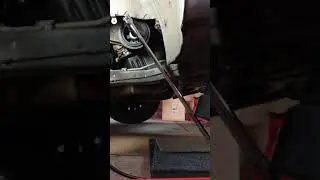 Loosening crankshaft bolt with starter and breaker bar.