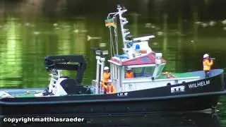 RC model boat Wilhelm pulls leash across the lake to clean.