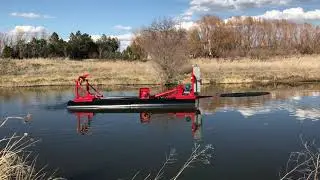 A Mud Cat Model MC 40E Dredge being used to clean out a lake in Colorado.