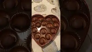 Unboxing a heart shape box of chocolates.