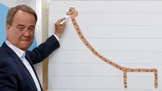 Armin Laschet malt eine Giraffe