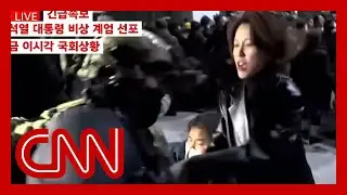 Soldier points rifle at lawmaker outside South Korean parliament