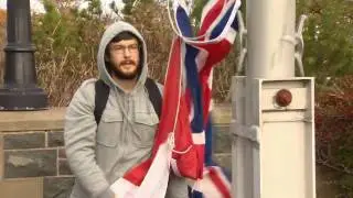 Protesters lower flags at Confederation Building