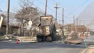Surveillance video shows moment dump truck crashes into pedestrian bridge