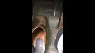 wooden brown Sanita Clogs in the Car / Pedal pumping