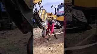Securing a crane hook: a construction worker's skill