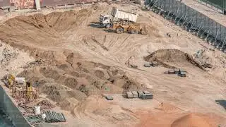 Wheel loader machine unloading sand at eathmoving works in construction site timelapse