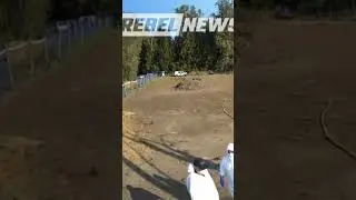 CFIA agents in hazmat suits being shamed by the Ostrich farm supporters as they walk through