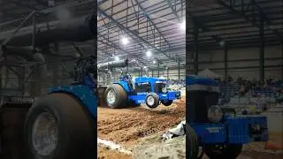 New Holland Tractor Wheels Up indoor tractor pulling.