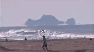 Inferior mirage of  distant rocks, sea surface and the waves