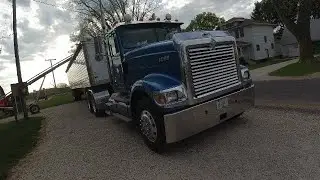 Unloading corn out of our corn crib