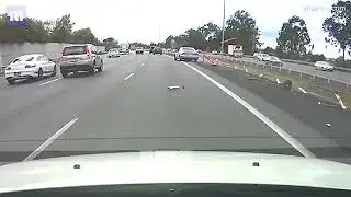 Terrifying moment a driver 'texting behind the wheel' before veering off the road and hitting