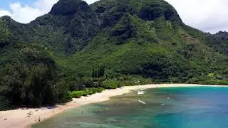 Stunning Tunnels Beach, extensive coral reefs, and Bali Hai background