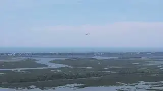 Drone footage of a low flying C-17 Globemaster and two F-16 Fighter jets