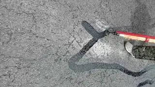 Clean and durable asphalt crack sealing results.