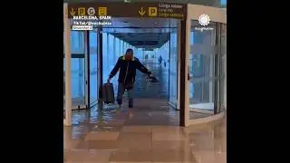 People Wading Through Water at Barcelona Airport