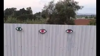 Drone hang street art on fence