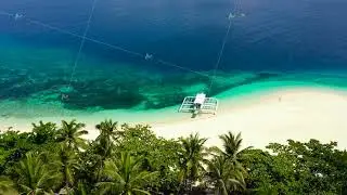 Perfect white sand beach with tropical trees. Mahaba Island, Philippines.