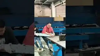Workers Collaborate to Assemble Complex Metal Parts