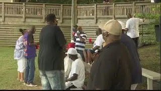 Community members hold vigil for Commissioner James Holmes