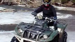 Lenka crossing river on ATV