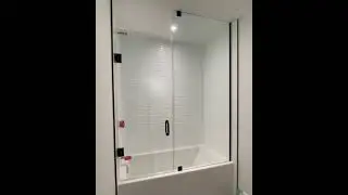Custom glass bathtub enclosure with Matte Black hardware.