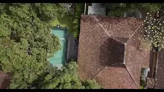 Aerial shot of a man jumping in a pool